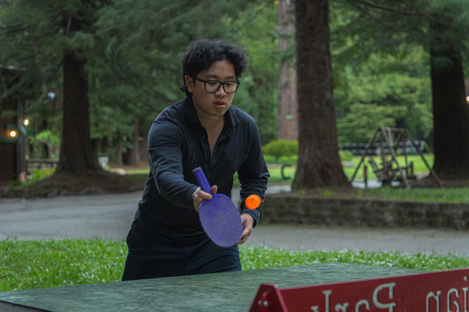 Nathaniel Mapaye playing table tennis outdoors